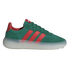A low-top Adidas sneaker with a dark green upper, three red stripes, and a thick, translucent white platform sole against a black background.