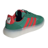 A three-quarter rear view of a green Adidas sneaker featuring red stripes and a thick, translucent white platform sole. The red heel tab is adorned with the Mexico national football team's eagle crest and the word "MÉXICO."