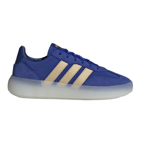 A side profile of a blue Adidas sneaker featuring gold three-stripes and a thick, semi-translucent white midsole. The shoe's upper is made of a mix of blue suede and fabric, with matching blue laces.