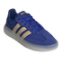An angled view of a royal blue Adidas sneaker featuring light tan side stripes and a thick, translucent white platform sole, set against a solid black background.
