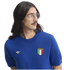 A man with long dark hair and a mustache wears a blue knit Adidas sweater with an Italia crest, looking to the side.