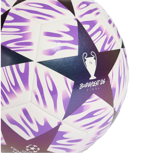 Close-up of a white soccer ball featuring purple wavy patterns and dark blue stars. One star displays a trophy icon and the text "BUDAPEST 26 FINAL".