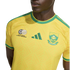 Close-up of a person wearing a yellow South Africa national football team jersey with green accents, featuring the Adidas logo and team crests.
