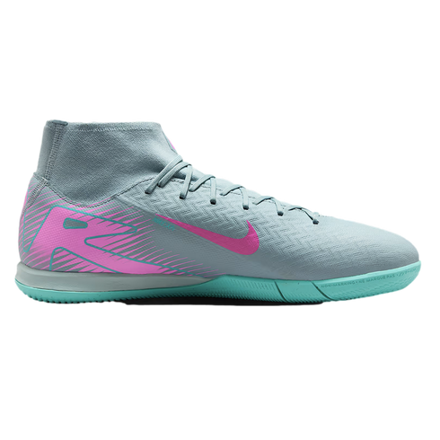 Grey Nike indoor soccer shoe with a pink swoosh and heel graphic, featuring a high-top sock-like collar and a turquoise flat rubber sole.