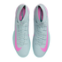 Top-down view of grey Nike Mercurial soccer shoes with pink Nike swooshes and teal accents along the soles.
