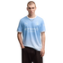 A man wearing a light blue Manchester City soccer jersey and dark pants, posing against a plain white background.