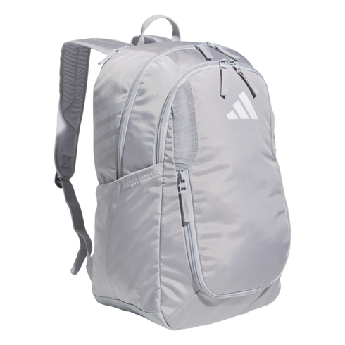 A light grey Adidas backpack featuring multiple zippered compartments, three stripes on the side, and a large logo on the front panel.
