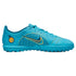 Side profile of a light blue Nike turf soccer shoe with dark blue and orange accents against a white background.