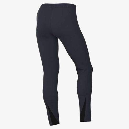 Rear view of dark navy blue athletic leggings with an elastic waistband and triangular black mesh panels at the back of the ankles.