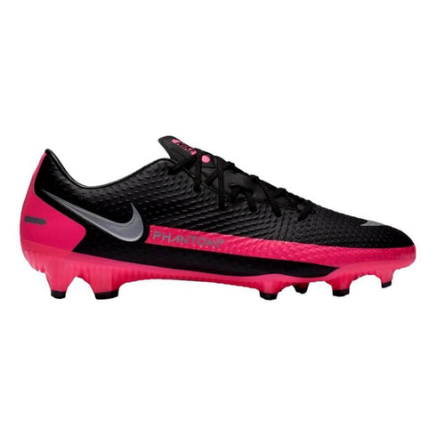 A side profile of a black Nike Phantom GT soccer cleat with a silver swoosh and a vibrant pink studded sole, set against a white background.